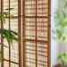Room divider ideas featuring wood slats, shelving, folding screens, glass partitions and curtains in warm stylish interiors
