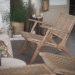 Deep round papasan rattan chair with a thick cream cushion in a warm boho reading nook